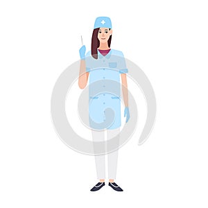 Smiling female doctor or nurse wearing scrubs and holding syringe. Young woman medic or surgeon dressed in medical