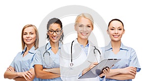 Smiling female doctor and nurses with stethoscope