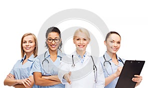 Smiling female doctor and nurses with stethoscope