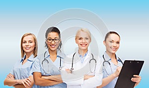 Smiling female doctor and nurses with stethoscope