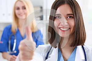 Smiling female doctor showing ok sign