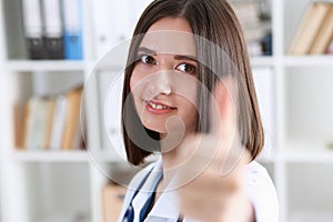 Smiling female doctor showing ok sign