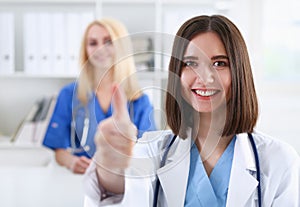 Smiling female doctor showing ok sign