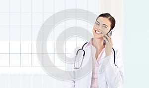 smiling female Doctor talks to the cell phone, concept of medical worker