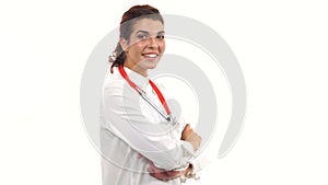 Smiling female doctor waving her hand, crossing arms and looking at camera. Portrait of young medical professional with