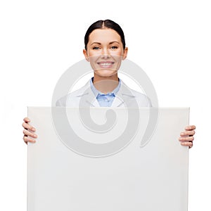 Smiling female doctor with white blank board