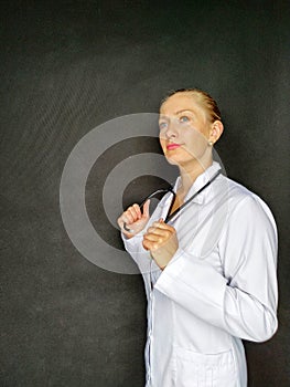 Smiling female doctor in white coat holding stethoscope