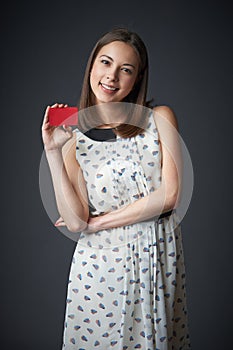 Smiling female in dress with business card