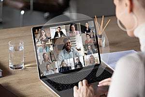 Smiling female employee holding video conference call with colleagues.