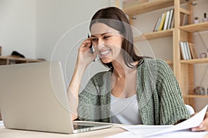 Smiling female employee laugh watching webinar on laptop photo