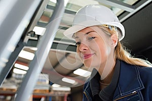 smiling female engineer wearing hardhat