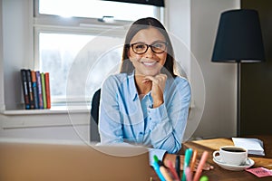 Smiling female entrepreneur at her desk