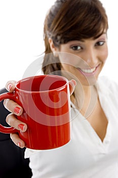 Smiling female executive holding coffee mug