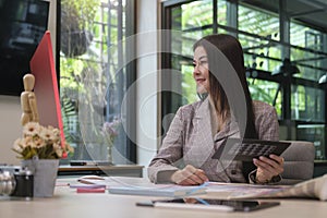 Smiling female graphic designer working with new startup project in modern office