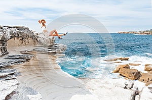 Smiling female, happy days basking in the summer sunshine by the ocean