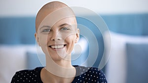 Smiling female having oncology look at camera motivated to survive