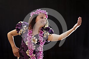 Smiling female Hawaiian girl dancing and singing with musical instruments like the ukulele