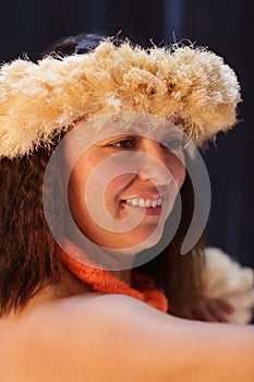 Smiling female Hawaiian girl dancing and singing with musical instruments like the ukulele