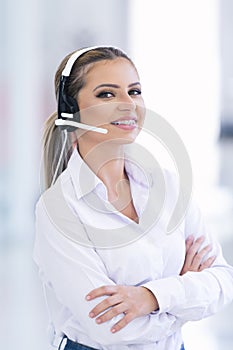 Smiling female helpline operator with headphones