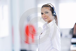 Smiling female helpline operator with headphones