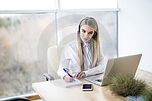 Smiling female helpline operator with headphones