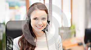 Smiling female helpline operator with headset