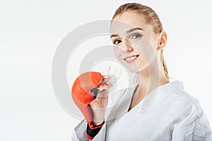 smiling female karate fighter holding mouthguard photo