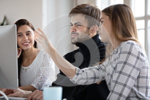 Smiling female male businesspeople working on project.