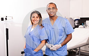 Smiling female and male cosmetologists in medical center