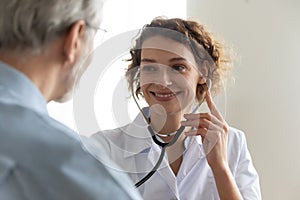 Smiling female nurse examine mature male patient