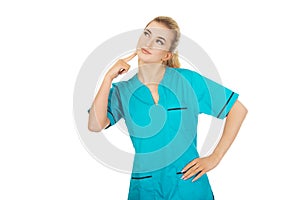 Smiling female nurse thinking about some idea