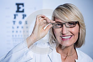 Smiling female optometrist wearing spectacles
