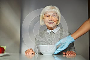 Smiling female pensioner anticipating her morning meal