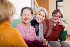 Smiling female pensioners on sofa