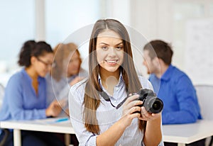 Smiling female photographer with photocamera