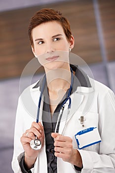 Smiling female physician in smock photo