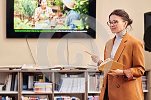 Smiling Female Professor Giving Lecture in College