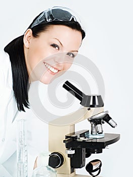 Smiling female researcher working on micr