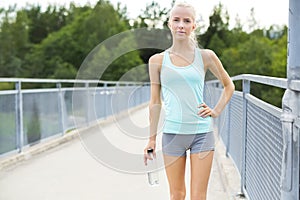 Smiling female runner taking a break after running