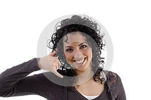 Smiling female showing telephonic gesture