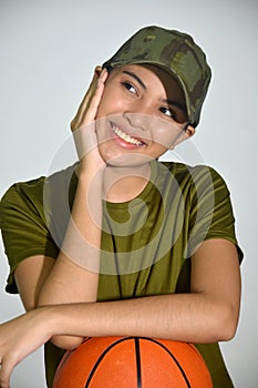 A Smiling Female Soldier With Basketball