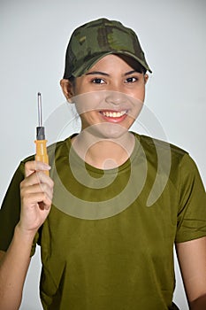 A Smiling Female Soldier With Screwdriver
