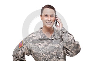 Smiling female soldier using mobile phone