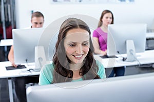 Smiling female student in computer class