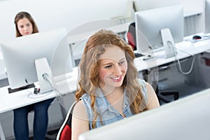 Smiling female student in computer class