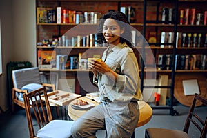 Smiling female student in library cafe