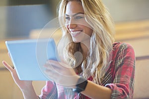 Smiling female student using tablet