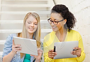 Smiling female students with tablet pc computer