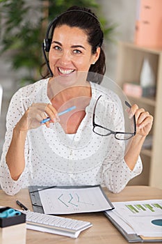 smiling female telesales agent wear wireless headset photo