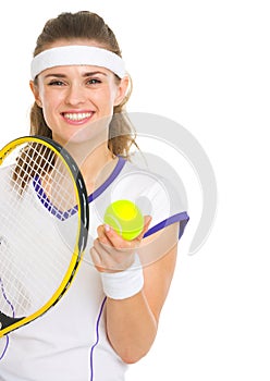 Smiling female tennis player with racket and ball